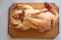 Raw bird carcass on a cutting board