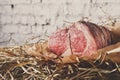 Raw aged prime black angus beef in craft papper on straw