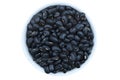 Raw black beans in white tile bowl isolated Royalty Free Stock Photo