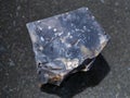 raw black Flint stone on dark background