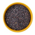 Raw black rice in round bowl cutout on white Royalty Free Stock Photo