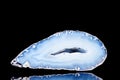 Raw blue agate mineral stone in front of black background Royalty Free Stock Photo