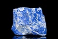 Raw blue lapis lazuli mineral stone in front of black background Royalty Free Stock Photo