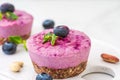 Raw blueberry and acai vegan cheesecakes with fresh berries, mint, nuts. healthy vegan food concept