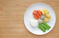 Raw of boiled vegetables baby food carrot, egg, potato, rice and sweet pea in white plate Royalty Free Stock Photo