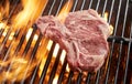 Raw bone-in pork steak grilling on a BBQ fire Royalty Free Stock Photo