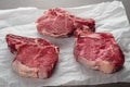 Raw Bone-in Rib eye Steak on wooden background Royalty Free Stock Photo