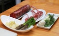 Raw boneless beef, bone rib-eye steak on a plate with onion, garlic and garnish ingredients on a kitchen table Royalty Free Stock Photo