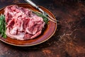 Raw Boneless Lamb leg meat in rustic plate with thyme. Dark background. Top view. Copy space Royalty Free Stock Photo