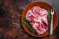 Raw Boneless Lamb leg meat in rustic plate with thyme. Dark background. Top view. Copy space Royalty Free Stock Photo