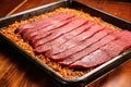 raw brisket in a roasting pan being probed Royalty Free Stock Photo