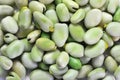 Raw broad beans (Vicia faba) are scattered as a background Royalty Free Stock Photo