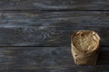 Raw brown long-grain rice in a paper craft bag on a wooden background Royalty Free Stock Photo