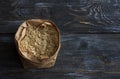 Raw brown long-grain rice in a paper craft bag on a wooden background Royalty Free Stock Photo