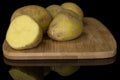 Raw brown potato isolated on black glass Royalty Free Stock Photo