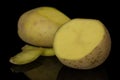 Raw brown potato isolated on black glass Royalty Free Stock Photo