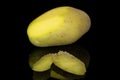 Raw brown potato isolated on black glass Royalty Free Stock Photo