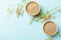 Raw brown quinoa seed in a wooden bowl on pastel color background