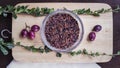 Raw brown rice, herbs and berries on chopping board flat lay