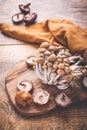 Raw brown shimeji mushrooms and shiitake on cutting board