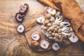 Raw brown shimeji mushrooms and shiitake on cutting board