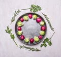 Raw Brussels sprouts and radishes with herbs in a frying pan on wooden rustic background top view close up place text,frame Royalty Free Stock Photo