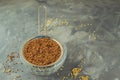 Raw buckwheat lies in a small strainer