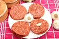 Raw burger patties with garlic