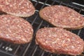Raw Burgers on a Barbecue Royalty Free Stock Photo