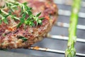 Raw burgers on bbq barbecue grill with fire Royalty Free Stock Photo