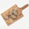 Raw burgers cutlets from organic beef meat on wooden cutting board isolated on white Royalty Free Stock Photo