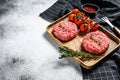 Raw burgers cutlets, organic ground beef meat. Gray background. Top view. Copy space Royalty Free Stock Photo