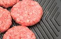 Raw burgers on a griddle Royalty Free Stock Photo