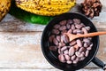 Raw cacao beans and cocoa pods on wooden boards. Royalty Free Stock Photo