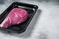 Raw cap rump steak or top sirloin beef meat steak in vacuum packaging. White background. Top view. Copy space Royalty Free Stock Photo