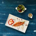 Raw carrots and bell pepper slice on flat rectangular plate