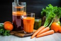 raw carrots, a juicer, and a glass of juice