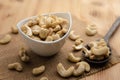 Raw cashew nuts in ceramic bowl on rustic table, healthy vegetarian snack Royalty Free Stock Photo