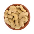 Raw cashews in a small bowl on a white background