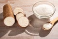 Raw cassava starch - Manihot esculenta. Wood background