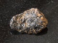 Raw Cassiterite Tin ore stone on black Royalty Free Stock Photo
