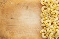 Macaroni rigati Beautiful laid out pasta with the right, side on a wooden plank texture background. Close-up view from