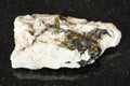 raw Chalcopyrite crystals in quartz rock on black