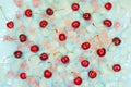 Raw cherry fruits against the background of transparent and blue ice cubes. Fresh summer pattern. Top view Royalty Free Stock Photo