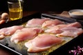 raw chicken being brushed with oil before going in the oven Royalty Free Stock Photo