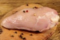 Raw chicken breast on cutting board on wooden table Royalty Free Stock Photo