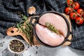 Raw chicken breast fillet in a pan with herbs and spices. White background. Top view