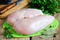 Raw chicken breast fillets on a cutting board on a wooden table Royalty Free Stock Photo