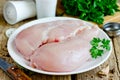 Raw chicken breast fillets on plate on wooden table Royalty Free Stock Photo