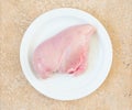 Raw chicken breast fillets on a white plate top view Royalty Free Stock Photo